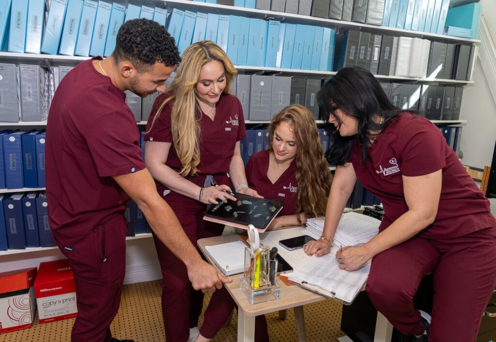 home health care providers discussing and showing something on a tablet