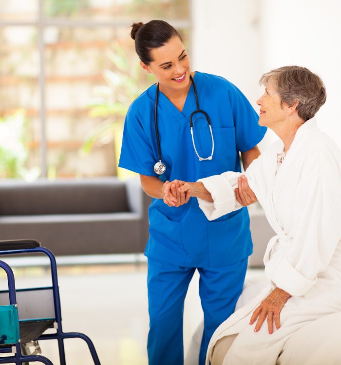 caregiver helping senior woman