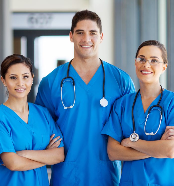 group of young hospital workers in scrubs